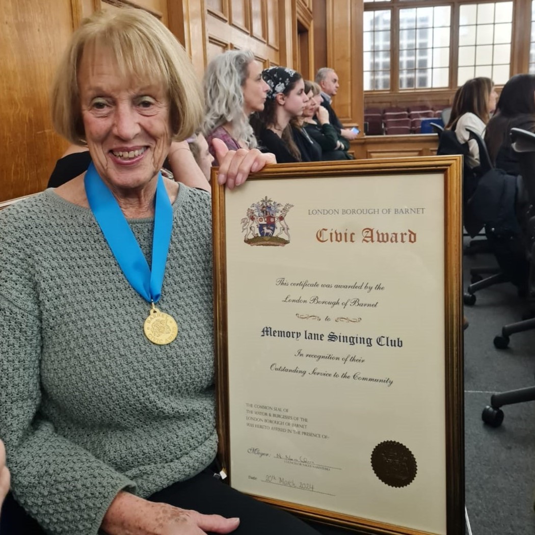Woman with blonde hair holding certificate
